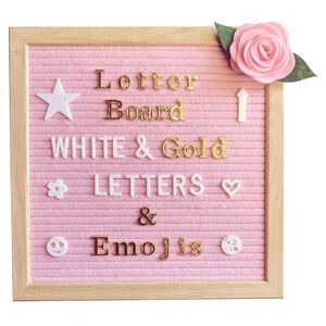 Pink felt letter board with white and gold letters and emojis